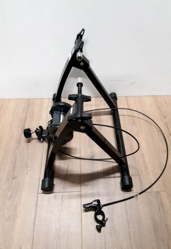 A BICYCLE TRAINER WITH VARIABLE SPEED HANDLEBAR ADJUSTER