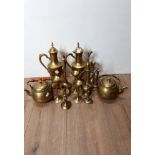 A QUANTITY OF EASTERN BRASS TEAPOTS AND CANDLE STICKS