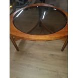 A VINTAGE GLASS TOP COFFE TABLE