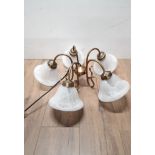 A BOXED FIVE ARMED BRASS EFFECT CHANDELIER WITH FROSTED GLASS SHADES