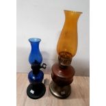 TWO COLOURED GLASS OIL LAMPS