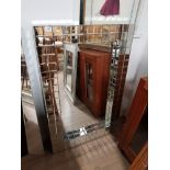 AN ALL GLASS HALL MIRROR WITH CUBE DESIGN GLASS FRAME
