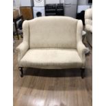 A WING BACK QUEEN ANNE STYLE TWO SEATER SOFA WITH CABRIOLE LEGS