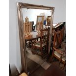 A LARGE SILVER BEVELLED EDGED MIRROR