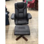 A REVOLVING LEATHERETTE ARMCHAIR AN MATCHING FOOTSTOOL