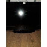 A 32 INCH DIGIHOME TV WITH REMOTE