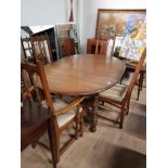 AN ERCOL TABLE AND FOUR CARVED ERCOL DINING CHAIRS