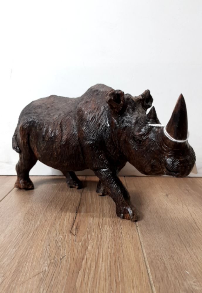 A CARVED RESIN RHINO ORNAMENT