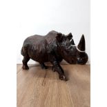 A CARVED RESIN RHINO ORNAMENT