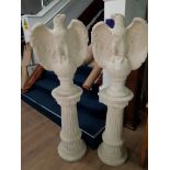 A PAIR OF FACING EAGLES ON ROMAN COLUMN PLINTHS 148CM HIGH