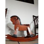 A WOODEN ROCKING HORSE