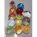 13 COLOURED GLASS PAPERWEIGHTS