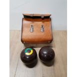 A NICE LEATHER BAG CONTAINING LAWN GREEN BOWLS