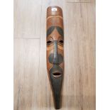 A WOODEN TRIBAL MASK