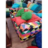 2 SEATER SOFA UPHOLSTERED IN A MULTI COLOUR PATTERN WITH SCATTER CUSHIONS