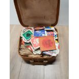 A VINTAGE LEATHER BAG WITH ASSORTED BEER MATS
