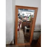 A WOODEN FRAMED MIRROR