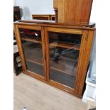 OAK GLAZED DOOR BOOKCASE WITH BRASS HANDLE