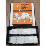 A STANLEY GIBBONS STAMP CATALOGUE AND BOX CONTAINING STAMPS FROM AROUND THE WORLD