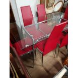 GLASS TOPPED TABLE WITH CHROME SUPPORTS AND 6 LEATHERETTE CHAIRS