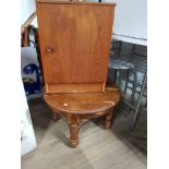 A SINGLE DOOR CUPBOARD TOGETHER WITH A CIRCULAR TOPPED OCCASIONAL TABLE