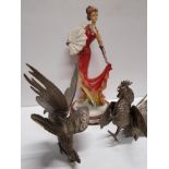 A PAIR OF METAL COCKERELS AND A VOGUE LADY FIGURINE