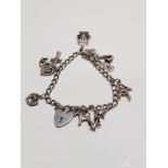 SILVER CURB BRACELET AND CHARMS GROSS WEIGHT 24G