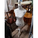 A SHOP MANNEQUIN ON PEDESTAL BASE