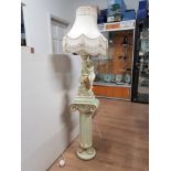 CREAM AND GILT LADY FIGURED TABLE LAMP AND SHADE ON GREEK COLUMN PEDESTAL STAND