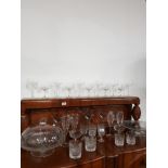 A SUBSTANTIAL AMOUNT OF GLASS WARE INC GLASS CAKE STANDS ONE WITH GLASS DOME LID ETC