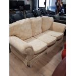 THREE SEATER UPHOLSTERED SETTEE WITH CREAM FLORAL PATTERN