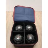 A SET OF 4 ALMARK LAWN GREEN BOWLS IN CARRY CASE