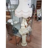 CREAM AND GILT LADY FIGURED TABLE LAMP AND SHADE ON GREEK COLUMN PEDESTAL STAND