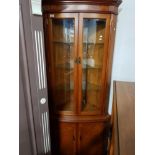 A MODERN YEW WOOD CORNER CABINET