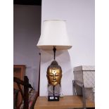 A DECORATIVE TABLE LAMP WITH A GILT BUDDHA HEAD