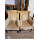 A PAIR OF EDWARDIAN STYLE CLUB CHAIRS ON CASTERS