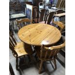 PINE CIRCULAR TOPPED DROP LEAF TABLE AND FOUR MATCHING PINE CHAIRS