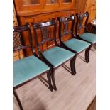 A SET OF 4 BLACK REGENCY STYLE DINING CHAIRS SPLAT BACK AND SABRE LEGS