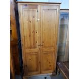 A PINE DOUBLE DOOR WARDROBE