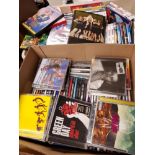 A BOX OF ASSORTED DVDS AND A BOX OF CDS 0