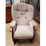 AN UPHOLSTERED ROCKING CHAIR