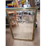 A MODERN GILT FRAMES MIRROR WITH BEVELLED EDGES