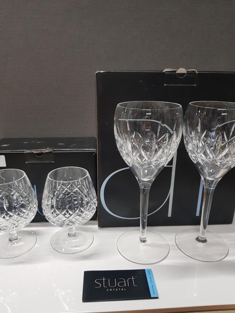 A PAIR OF STUART CRYSTAL BRANDY BALLOONS TOGETHER WITH A PAIR OF STUART CRYSTAL WINE GLASSES BOTH