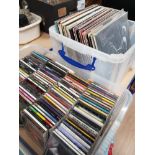 A BOX OF ASSORTED CDS AND A BOX OF LP RECORDS