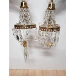 A PAIR OF BRASS CHANDELIERS WITH CRYSTAL DROPS