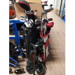2 GOLF BAGS BOTH CONTAINING CLUBS TOGETHER WITH A GOLF TROLLEY