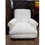 LOW ARM CHAIR ON BRASS CASTERS WITH WASHABLE COVERS