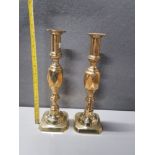 A PAIR OF BRASS CANDLESTICKS