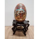 JAPANESE STYLE DECORATIVE EGG ON WOODEN PLINTH EGG IS 31CM HIGH