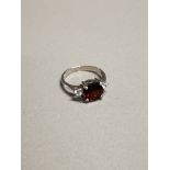 SILVER AND GARNET RING SIZE J 2.1G